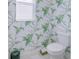 Stylish powder room features unique floral wallpaper and modern fixtures at 19475 Bristol Wood Pl, Brooksville, FL 34601