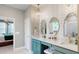 Elegant bathroom featuring dual sinks, vanity with chandeliers, and shiplap wall at 19475 Bristol Wood Pl, Brooksville, FL 34601