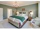 Beautifully decorated bedroom with decorative pillows, chandelier, and green walls at 19475 Bristol Wood Pl, Brooksville, FL 34601