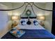 Comfortable bedroom features decorative pillows, wreath accent, and ambient lighting at 19475 Bristol Wood Pl, Brooksville, FL 34601