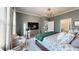 Bedroom featuring large window, television, chandelier, and doorway to bathroom at 19475 Bristol Wood Pl, Brooksville, FL 34601