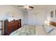 Bright bedroom with ceiling fan, floral bedding, and spacious closet doors at 19475 Bristol Wood Pl, Brooksville, FL 34601