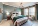 Beautiful bedroom with an elegant chandelier and stylish decor and neutral color palette at 19475 Bristol Wood Pl, Brooksville, FL 34601