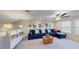 Bonus room featuring a plush sofa, shelving with decorations and natural light from the window at 19475 Bristol Wood Pl, Brooksville, FL 34601