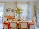 Dining room featuring a wooden table, upholstered chairs, a buffet, and floral curtains at 19475 Bristol Wood Pl, Brooksville, FL 34601