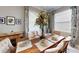 Elegant dining room with a wooden table, upholstered chairs, and decorative curtains and artwork at 19475 Bristol Wood Pl, Brooksville, FL 34601