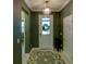 Home entrance featuring a decorative chandelier, front door with a glass window and wooden floors at 19475 Bristol Wood Pl, Brooksville, FL 34601