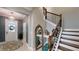 A foyer showcases a staircase, mirror, decor, and an inviting entrance with a patterned rug at 19475 Bristol Wood Pl, Brooksville, FL 34601