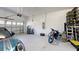 Spacious two car garage with a hot water heater, bikes, and a Mini Cooper at 19475 Bristol Wood Pl, Brooksville, FL 34601