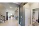 Bright hallway with access to living room and bathroom, featuring wood look tile floors at 19475 Bristol Wood Pl, Brooksville, FL 34601