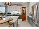 Modern kitchen with stainless steel appliances, a center island, and an ornate door leading to a pantry at 19475 Bristol Wood Pl, Brooksville, FL 34601