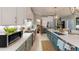 Open kitchen with stainless steel appliances, a pantry, a center island with sink and quartz countertops at 19475 Bristol Wood Pl, Brooksville, FL 34601