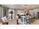 Bright kitchen featuring white cabinets, modern appliances, a kitchen island with seating, and a dining table at 19475 Bristol Wood Pl, Brooksville, FL 34601