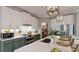 Well-appointed kitchen with stainless steel appliances, a pantry, a center island with sink and quartz countertops at 19475 Bristol Wood Pl, Brooksville, FL 34601