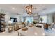 Open floor plan featuring kitchen with an island and eat in bar flowing to the living and dining areas at 19475 Bristol Wood Pl, Brooksville, FL 34601