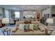 Inviting living room with a comfortable sofa and a view into the stylish kitchen and dining area at 19475 Bristol Wood Pl, Brooksville, FL 34601