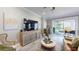 Bright living room showcasing an entertainment center, accent chairs, and access to the outdoor space at 19475 Bristol Wood Pl, Brooksville, FL 34601