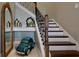 A wooden staircase features a decorative model car, mirror and small decorations at 19475 Bristol Wood Pl, Brooksville, FL 34601