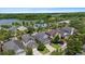 Aerial view of a neighborhood featuring well-kept homes, mature trees, and a peaceful lake at 20113 Bending Creek Pl, Tampa, FL 33647