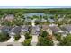 Beautiful aerial view of a residential area with green landscaping and a serene lake in the background at 20113 Bending Creek Pl, Tampa, FL 33647