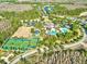 Aerial view of community featuring clubhouse, pool, playground, tennis courts, and lush landscaping at 20113 Bending Creek Pl, Tampa, FL 33647