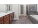 Bright primary bathroom featuring a double sink vanity, standalone shower, and a soaking tub at 20113 Bending Creek Pl, Tampa, FL 33647