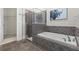 Tiled bathroom featuring shower, tub combination and decorative wall art at 20113 Bending Creek Pl, Tampa, FL 33647