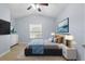 Comfortable bedroom with blue and gray decor, carpet flooring, natural light, and a ceiling fan at 20113 Bending Creek Pl, Tampa, FL 33647