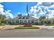 Stately clubhouse with classic architectural details, manicured landscaping, and an American flag flying high on a beautiful day at 20113 Bending Creek Pl, Tampa, FL 33647