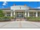 Elegant clubhouse entrance with a covered portico, manicured hedges, and symmetrical design elements at 20113 Bending Creek Pl, Tampa, FL 33647