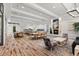 Expansive common room with dining tables, a kitchen island, fireplace, and cozy seating area at 20113 Bending Creek Pl, Tampa, FL 33647