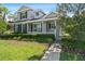 Inviting two-story home with a charming front porch, well-maintained landscaping, and classic architectural details at 20113 Bending Creek Pl, Tampa, FL 33647