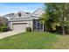 Charming home featuring a two-car garage, manicured lawn, and a screened-in patio perfect for outdoor living at 20113 Bending Creek Pl, Tampa, FL 33647