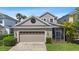 Charming home featuring a two-car garage, manicured lawn, and a screened-in patio perfect for outdoor living at 20113 Bending Creek Pl, Tampa, FL 33647