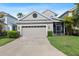 Charming home featuring a two-car garage, manicured lawn, and a screened-in patio perfect for outdoor living at 20113 Bending Creek Pl, Tampa, FL 33647