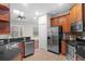 Bright eat-in kitchen with stainless steel appliances, a skylight, and dark granite countertops at 20113 Bending Creek Pl, Tampa, FL 33647