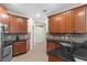 Kitchen with sleek stainless steel appliances, granite countertops, and tile flooring at 20113 Bending Creek Pl, Tampa, FL 33647