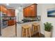 Cozy kitchen with stainless steel appliances, breakfast bar with barstool seating and wooden cabinets at 20113 Bending Creek Pl, Tampa, FL 33647