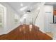 Bright, open-concept living room featuring hardwood floors, vaulted ceilings and a staircase at 20113 Bending Creek Pl, Tampa, FL 33647
