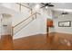 Open-concept living room with hardwood floors, staircase, and a view of the kitchen at 20113 Bending Creek Pl, Tampa, FL 33647