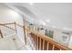 Bright loft area featuring wood railing, neutral walls, and ample natural light from multiple windows at 20113 Bending Creek Pl, Tampa, FL 33647