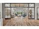 Bright and airy lounge area with stylish furnishings, wood flooring, and a view of lush greenery beyond glass doors at 20113 Bending Creek Pl, Tampa, FL 33647