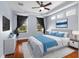 Serene main bedroom with tray ceiling, hardwood floors, and ample natural light at 20113 Bending Creek Pl, Tampa, FL 33647
