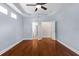 Empty main bedroom featuring hardwood floors and access to ensuite bathroom at 20113 Bending Creek Pl, Tampa, FL 33647