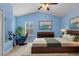 Spacious main bedroom with a serene blue color scheme, vaulted ceiling, and ample natural light at 20113 Bending Creek Pl, Tampa, FL 33647