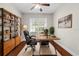 Comfortable office space with built-in shelving, hardwood floors, and a large window at 20113 Bending Creek Pl, Tampa, FL 33647