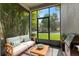 Screened patio area with outdoor furniture and grill at 20113 Bending Creek Pl, Tampa, FL 33647
