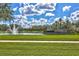 Picturesque view of a community pond with a fountain, gazebo, and lush green surroundings at 20113 Bending Creek Pl, Tampa, FL 33647