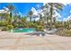 Beautiful resort-style pool area with palm trees, splash fountain and plenty of lounge chairs at 20113 Bending Creek Pl, Tampa, FL 33647