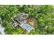 Aerial view of a well-maintained home featuring a new driveway, fenced yard, and mature landscaping at 2106 W Saint Isabel St, Tampa, FL 33607